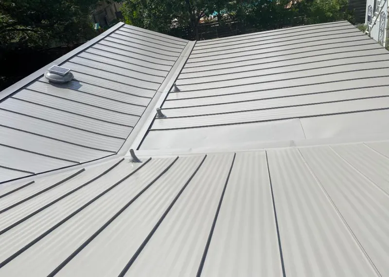 Solar attic fan installed on a metal roof for Roof Ventilation in Tanglewilde